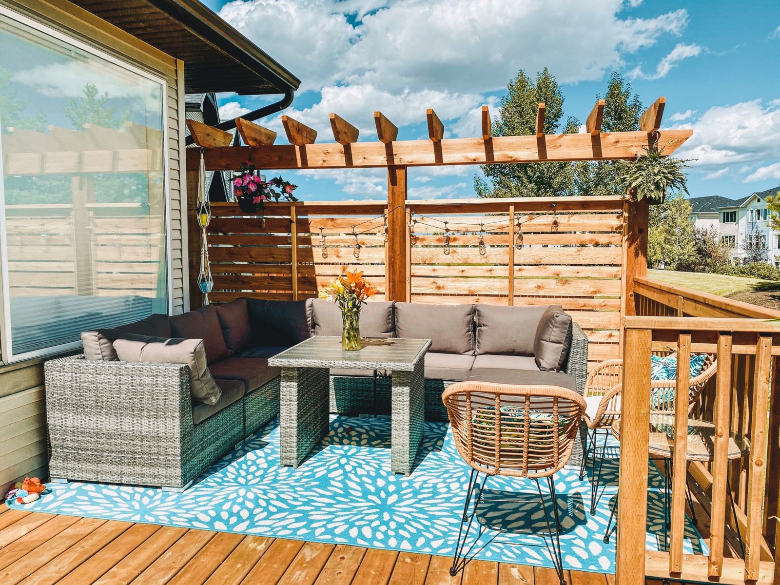 Custom cedar horizontal slat privacy wall with cedar arbor top by Busy Beaver Construction Calgary